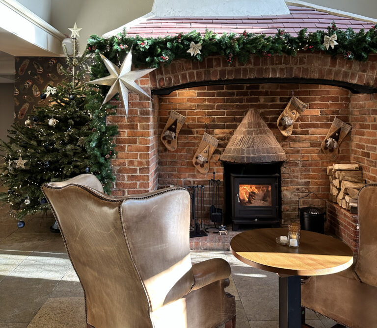 Fireplace at The Kingfisher with Christmas decorations